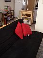 A view of the futon. The kitchen is in the background. 